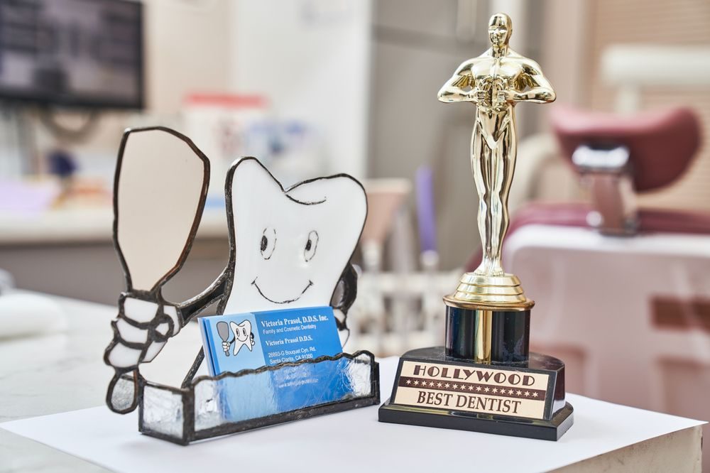 Best Dentist trophy and tooth-shaped card holder at the front desk